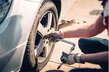 A man cleaning car engine with microfiber cloth. Car detailing or valeting concept. Selective focus. Car detailing. Cleaning with sponge. Worker cleaning. Car wash concept solution to clean